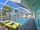 Resort-style pool and spa overlooking a serene waterway, complemented by lounge seating and lush tropical landscaping at 10016 Spoonbill E Rd, Bradenton, FL 34209