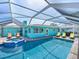 Outdoor pool and spa with comfortable seating and canal views, perfect for relaxation and outdoor entertaining at 10016 Spoonbill E Rd, Bradenton, FL 34209