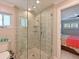 Beautiful shower features beige tile and frameless glass doors at 10016 Spoonbill E Rd, Bradenton, FL 34209