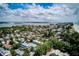 Aerial view of homes nestled amongst lush greenery, with a bay and bridge visible in the distance at 104 29Th St # 3, Holmes Beach, FL 34217