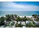 Aerial view of homes with convenient beach access and serene blue ocean and sky in the background at 104 29Th St # 3, Holmes Beach, FL 34217