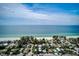 Stunning aerial view of beachfront homes, showcasing the proximity to the ocean and blue skies above at 104 29Th St # 3, Holmes Beach, FL 34217