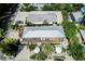An aerial view of the property showcasing the expansive deck, outdoor seating, and tropical landscaping at 104 29Th St # 3, Holmes Beach, FL 34217