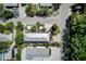 Detailed aerial view of a well-maintained home with lush landscaping, outdoor dining, and proximity to beach at 104 29Th St # 3, Holmes Beach, FL 34217