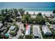 Gorgeous aerial view of a property near a pristine beach with lush greenery and calm ocean waters at 104 29Th St # 3, Holmes Beach, FL 34217