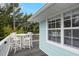Charming balcony with a stylish dining set, perfect for outdoor dining and enjoying the scenic views at 104 29Th St # 3, Holmes Beach, FL 34217