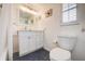 Well-lit bathroom featuring a toilet, modern vanity, and dark accent flooring at 104 29Th St # 3, Holmes Beach, FL 34217