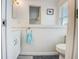 Cozy half bathroom with white fixtures, wainscoting, and a decorative towel rack at 104 29Th St # 3, Holmes Beach, FL 34217