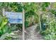 A shady path leads to the beach, with a Beach Access sign at 104 29Th St # 3, Holmes Beach, FL 34217