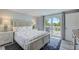 Inviting bedroom featuring a comfortable bed, bedside tables, and access to a balcony for a relaxing retreat at 104 29Th St # 3, Holmes Beach, FL 34217