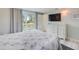 Relaxing bedroom with a queen-sized bed, a large dresser, and access to a private balcony at 104 29Th St # 3, Holmes Beach, FL 34217