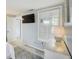 Well-lit bedroom with a TV, dresser, and ensuite bathroom ensures a comfortable and convenient stay at 104 29Th St # 3, Holmes Beach, FL 34217
