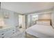 Bright bedroom with a comfortable bed, dresser, and ensuite bathroom at 104 29Th St # 3, Holmes Beach, FL 34217