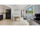 Bright dining area with a white table, adjacent kitchen, and sliding glass doors leading to a deck at 104 29Th St # 3, Holmes Beach, FL 34217
