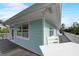 Exterior view of home showing the deck, railings, windows, and tropical foliage at 104 29Th St # 3, Holmes Beach, FL 34217