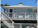 Inviting coastal-style home featuring a cozy, sunlit balcony perfect for relaxing and enjoying the outdoors at 104 29Th St # 3, Holmes Beach, FL 34217