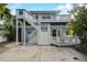 Charming multi-story beach house with white railings, private staircase, and ground floor patio space at 104 29Th St # 3, Holmes Beach, FL 34217
