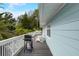 Inviting exterior view of a home's deck with white Adirondack chairs and a grill for outdoor dining at 104 29Th St # 3, Holmes Beach, FL 34217