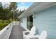 Exterior view of a coastal home featuring a deck with white railings and outdoor seating at 104 29Th St # 3, Holmes Beach, FL 34217