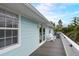 Charming exterior with a large deck, white railings, siding, and outdoor seating at 104 29Th St # 3, Holmes Beach, FL 34217
