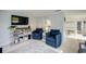 Bright living room featuring blue armchairs, tile flooring, and stylish décor, perfect for relaxation at 104 29Th St # 3, Holmes Beach, FL 34217