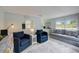Cozy living room with comfortable blue seating, light blue walls, and abundant natural light at 104 29Th St # 3, Holmes Beach, FL 34217