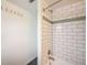 Detailed view of the bathtub and shower, featuring subway tile and modern fixtures at 104 29Th St # 3, Holmes Beach, FL 34217