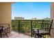 Private balcony with seating offers relaxing views of nearby resort and lush landscaping at 1064 N Tamiami Trl # 1425, Sarasota, FL 34236