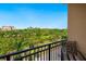Relaxing balcony view overlooking lush landscaping and distant buildings against a clear blue sky at 1064 N Tamiami Trl # 1425, Sarasota, FL 34236