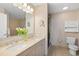 Bright bathroom featuring a double vanity, a shower, a toilet, and a vanity mirror at 1064 N Tamiami Trl # 1425, Sarasota, FL 34236