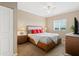 Bright bedroom featuring a ceiling fan, neutral walls, and a comfortable queen-sized bed with red pillows at 1064 N Tamiami Trl # 1425, Sarasota, FL 34236