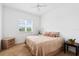 Bright bedroom with a large window, side table, and dresser at 1064 N Tamiami Trl # 1425, Sarasota, FL 34236