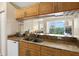 Open kitchen bar area with granite countertops and a view of the balcony at 1064 N Tamiami Trl # 1425, Sarasota, FL 34236