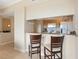 Kitchen bar with granite countertops and a view of the dining and living spaces at 1064 N Tamiami Trl # 1425, Sarasota, FL 34236
