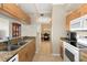 Bright kitchen with granite countertops, stainless steel appliances, and a view into the dining room at 1064 N Tamiami Trl # 1425, Sarasota, FL 34236