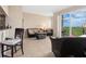 Bright living room features sliding glass doors to the balcony and tile floors at 1064 N Tamiami Trl # 1425, Sarasota, FL 34236