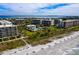 Scenic aerial view of beachfront condos and pristine beach with gulf coast in the background at 1095 Gulf Of Mexico Dr # 503, Longboat Key, FL 34228