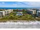 Breathtaking aerial view of beachfront condos, pool, and gulf coast in a pristine tropical setting at 1095 Gulf Of Mexico Dr # 503, Longboat Key, FL 34228