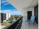 Private balcony with seating offers expansive views of the community and ocean at 1095 Gulf Of Mexico Dr # 503, Longboat Key, FL 34228