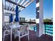 Balcony area with outdoor seating overlooking the community pool and lush tropical surroundings at 1095 Gulf Of Mexico Dr # 503, Longboat Key, FL 34228