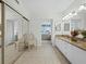 Bathroom boasts granite countertops and a chair that reflects in the mirrored closet doors at 1095 Gulf Of Mexico Dr # 503, Longboat Key, FL 34228