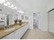 Bright bathroom featuring double sinks, granite countertops, and ample vanity storage at 1095 Gulf Of Mexico Dr # 503, Longboat Key, FL 34228