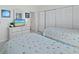 Bedroom featuring twin beds, a dresser, and closet doors at 1095 Gulf Of Mexico Dr # 503, Longboat Key, FL 34228
