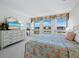 Bedroom showcasing a large dresser and a floral quilt at 1095 Gulf Of Mexico Dr # 503, Longboat Key, FL 34228