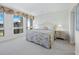 Bedroom featuring a large window, floral accents, and neutral tones at 1095 Gulf Of Mexico Dr # 503, Longboat Key, FL 34228