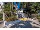 Building exterior featuring lush tropical landscaping and an exterior stairway at 1095 Gulf Of Mexico Dr # 503, Longboat Key, FL 34228