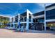 Modern condo building exterior with multiple levels, stairs to lobby, and outdoor lounging near the pool at 1095 Gulf Of Mexico Dr # 503, Longboat Key, FL 34228