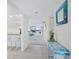 Hallway with tiled floors and light walls leading to the living space and views of the waterfront at 1095 Gulf Of Mexico Dr # 503, Longboat Key, FL 34228