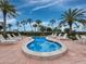 Hot tub surrounded by lounge chairs and lush landscaping at 1095 Gulf Of Mexico Dr # 503, Longboat Key, FL 34228