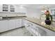 Kitchen featuring white cabinets, stainless steel appliances, granite countertops, and seating for two at 1095 Gulf Of Mexico Dr # 503, Longboat Key, FL 34228